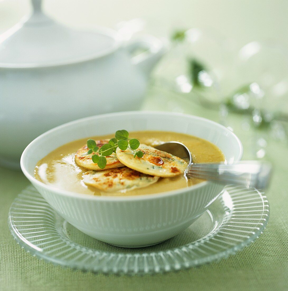 Creamy soup with potato pancakes