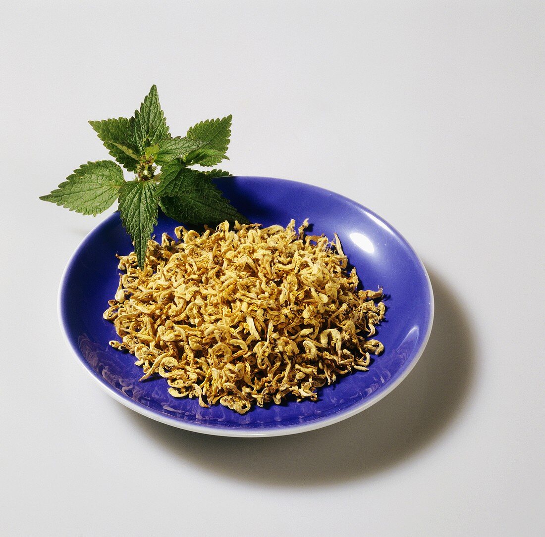 Dried nettle in blue dish