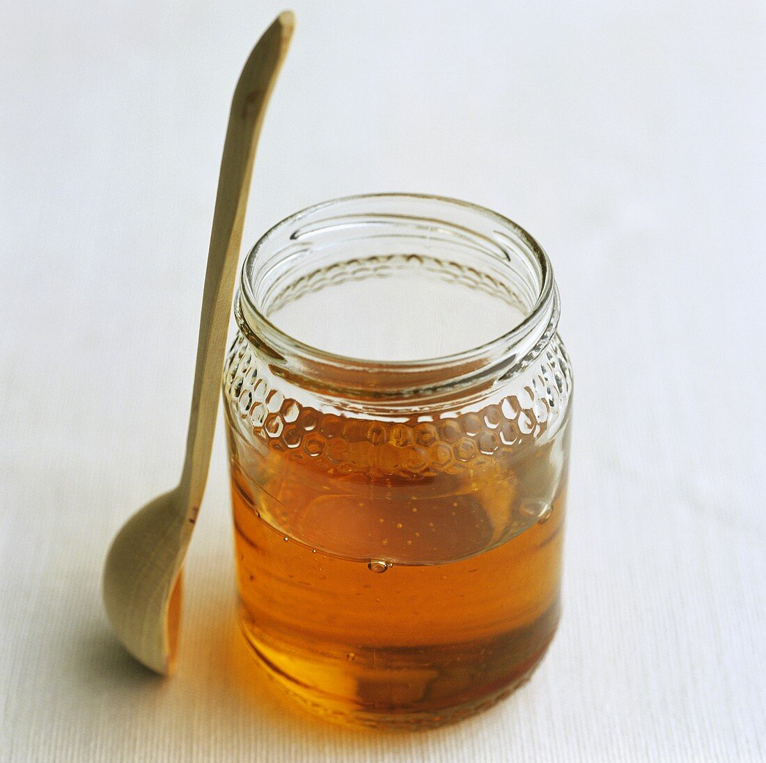 Jar of honey with honey spoon