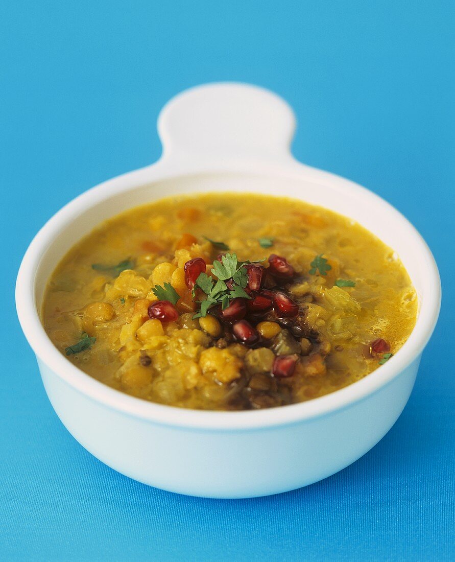 Lentil soup with pomegranate seeds and coriander