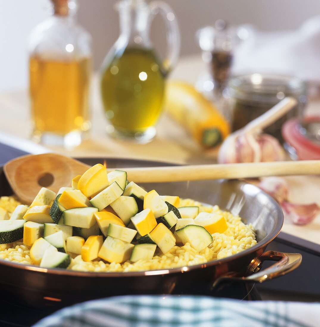 Ingredients for courgette risotto in a frying pan