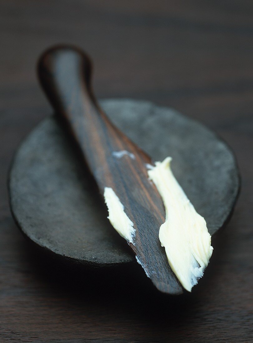 Butter on wooden knife