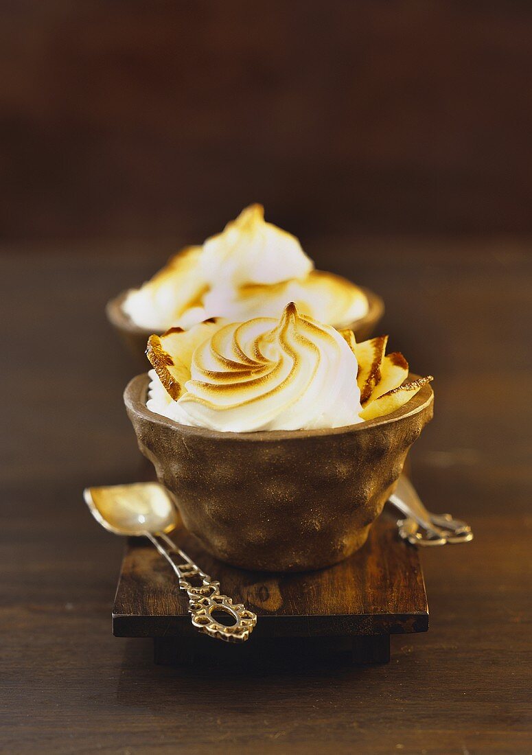 An apple cup cake with a meringue lid