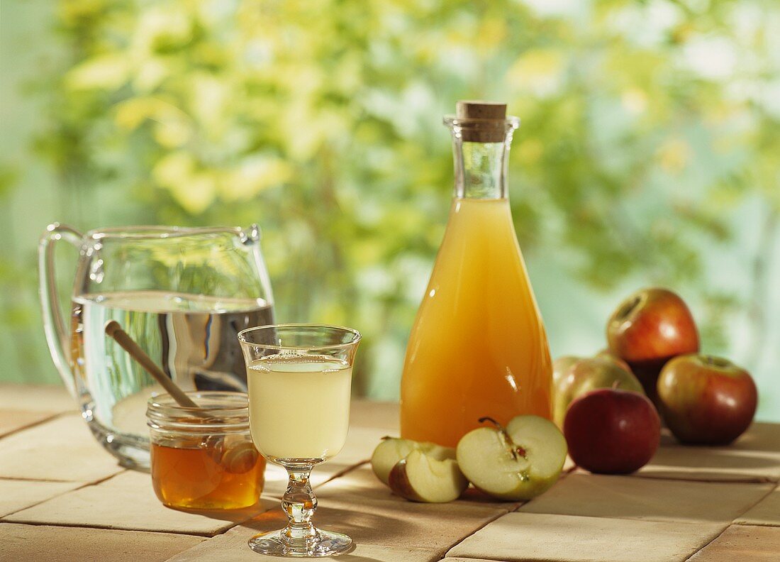 A display of apple vinegar and apples