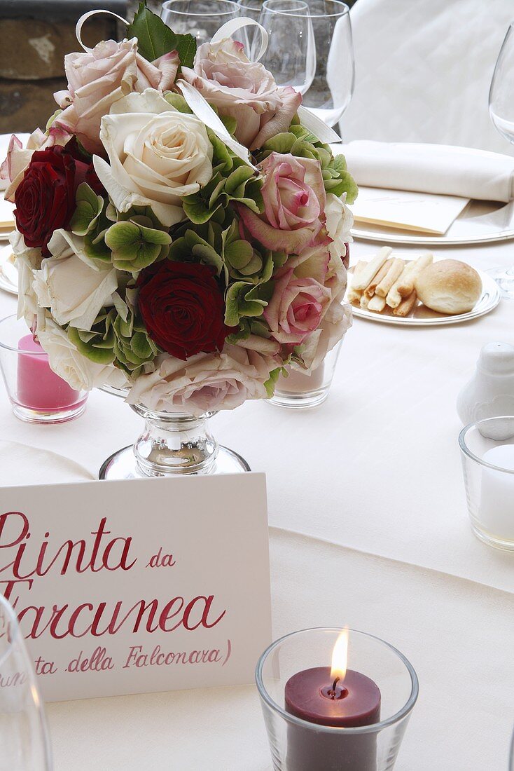 A bunch of roses on a festively laid table