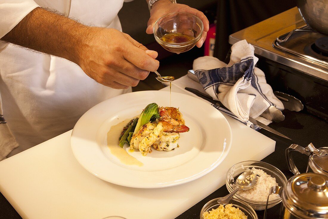 King prawns being drizzled with honey sauce