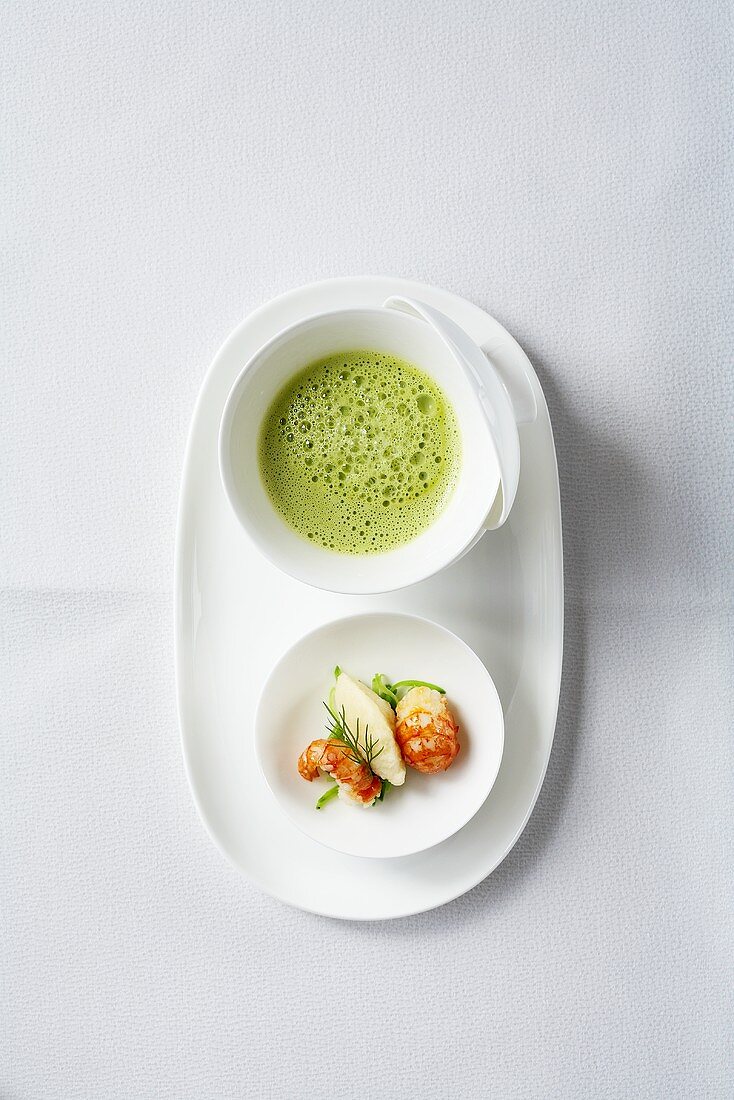 Pea and lettuce soup with semolina dumplings and crayfish