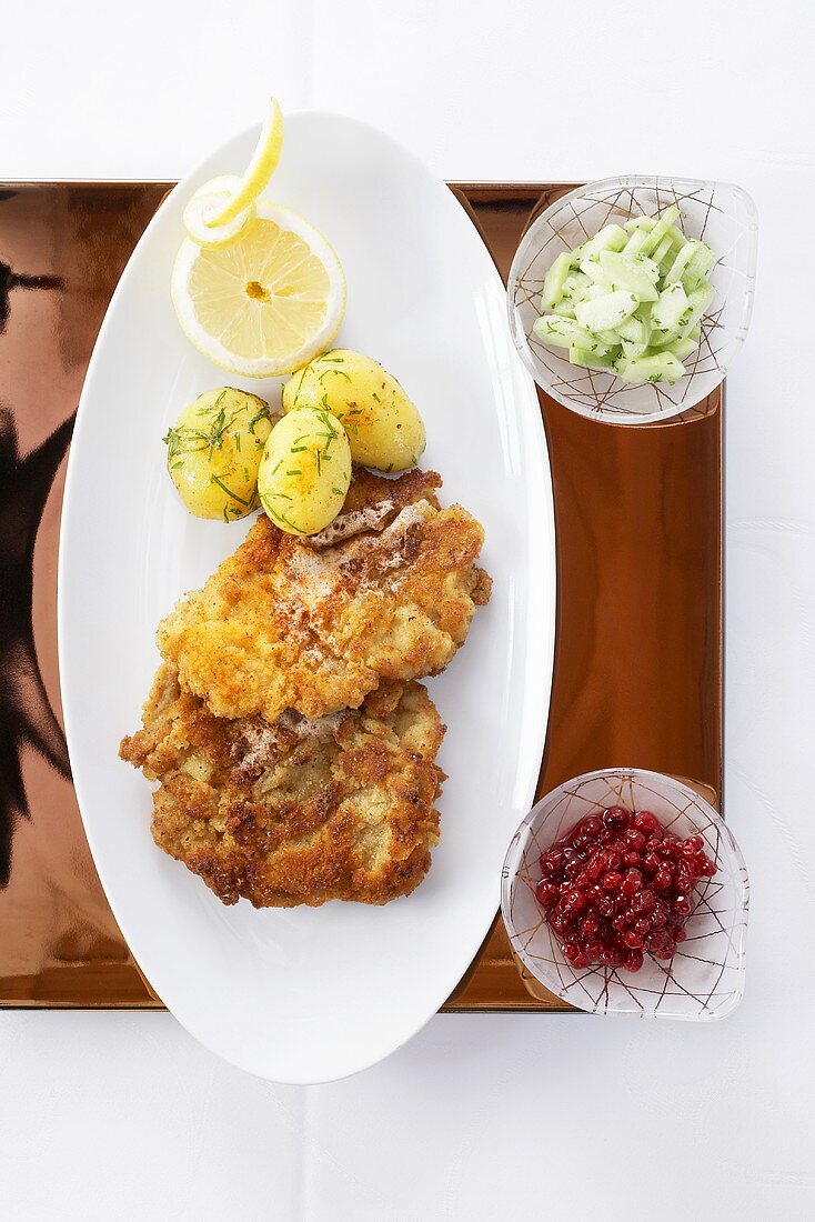 Veal escalope with parsley potatoes and cucumber salad