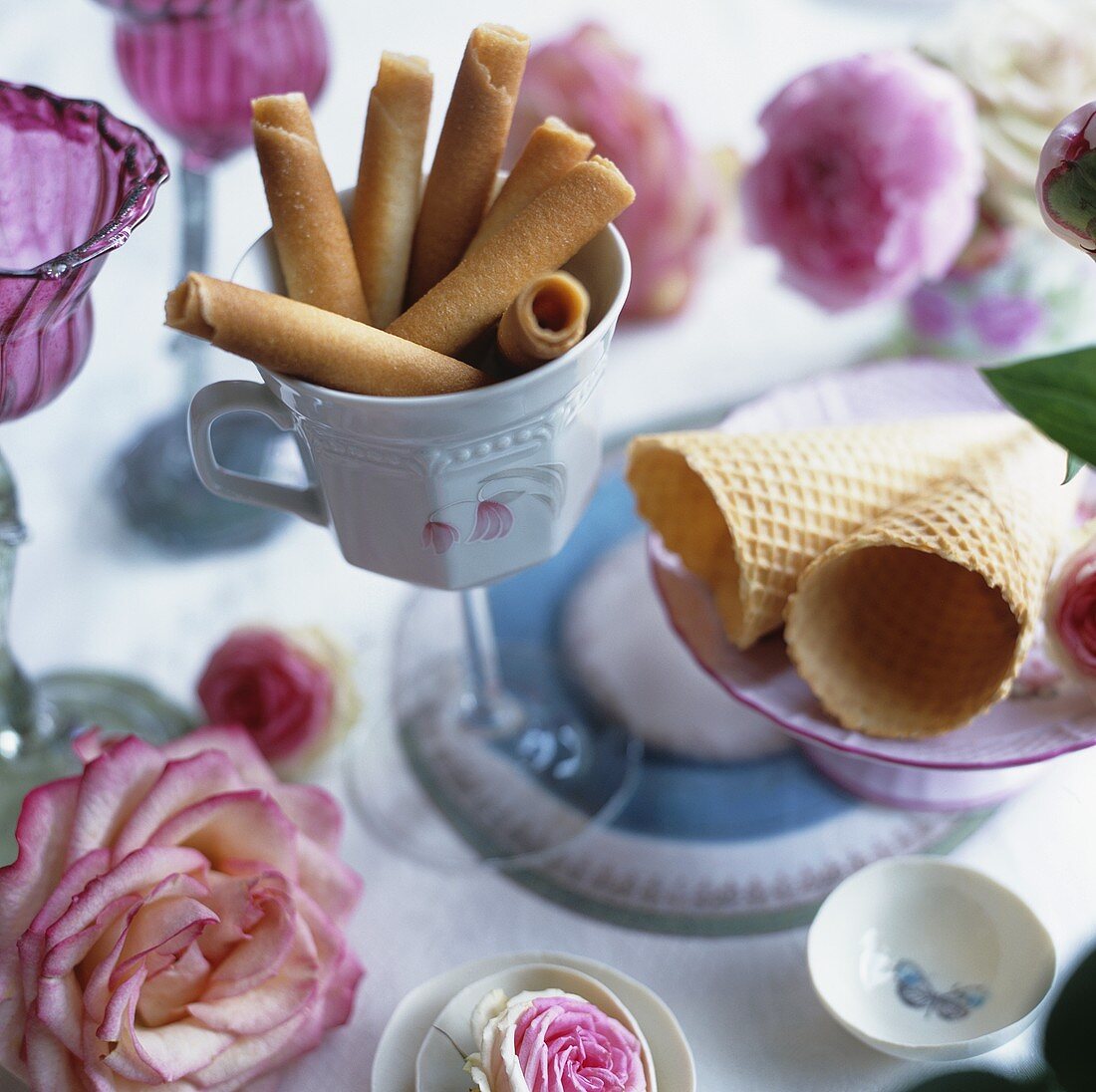 Ice cream cones and biscuit rolls surrounded by roses