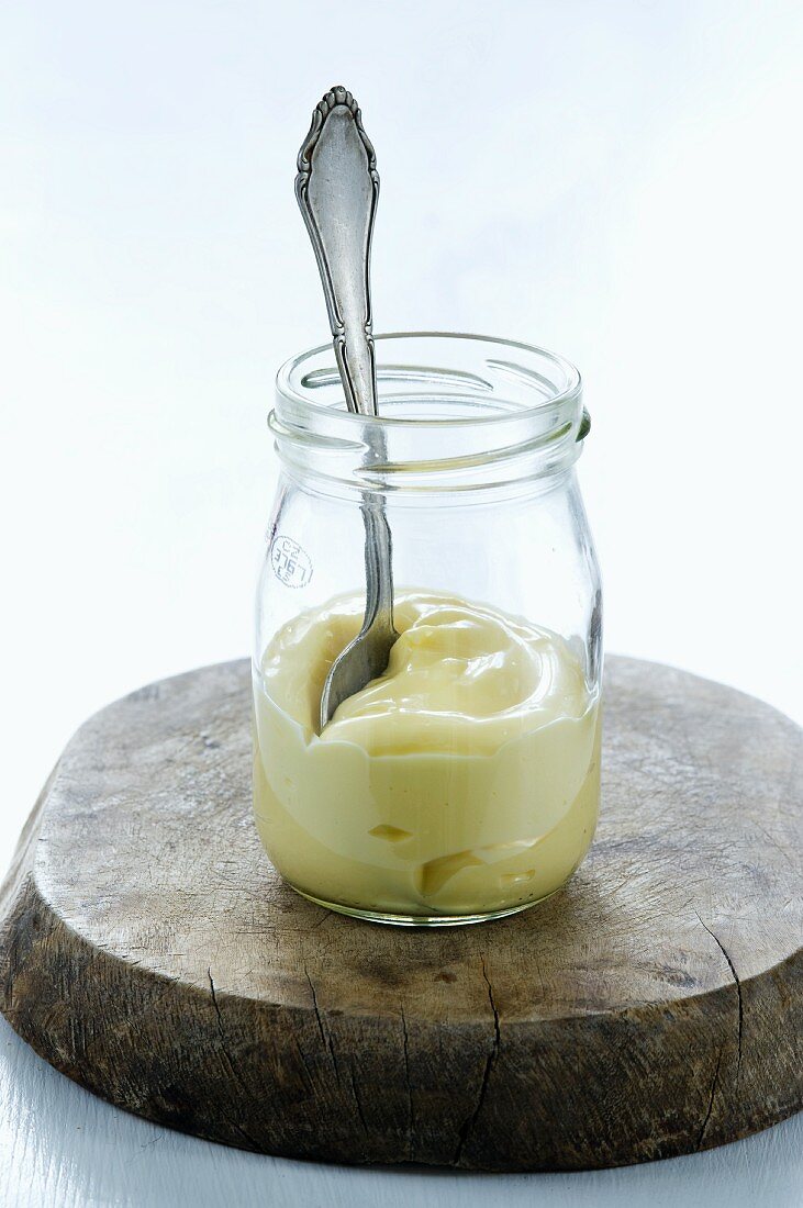 A spoon in a jar of mayonnaise