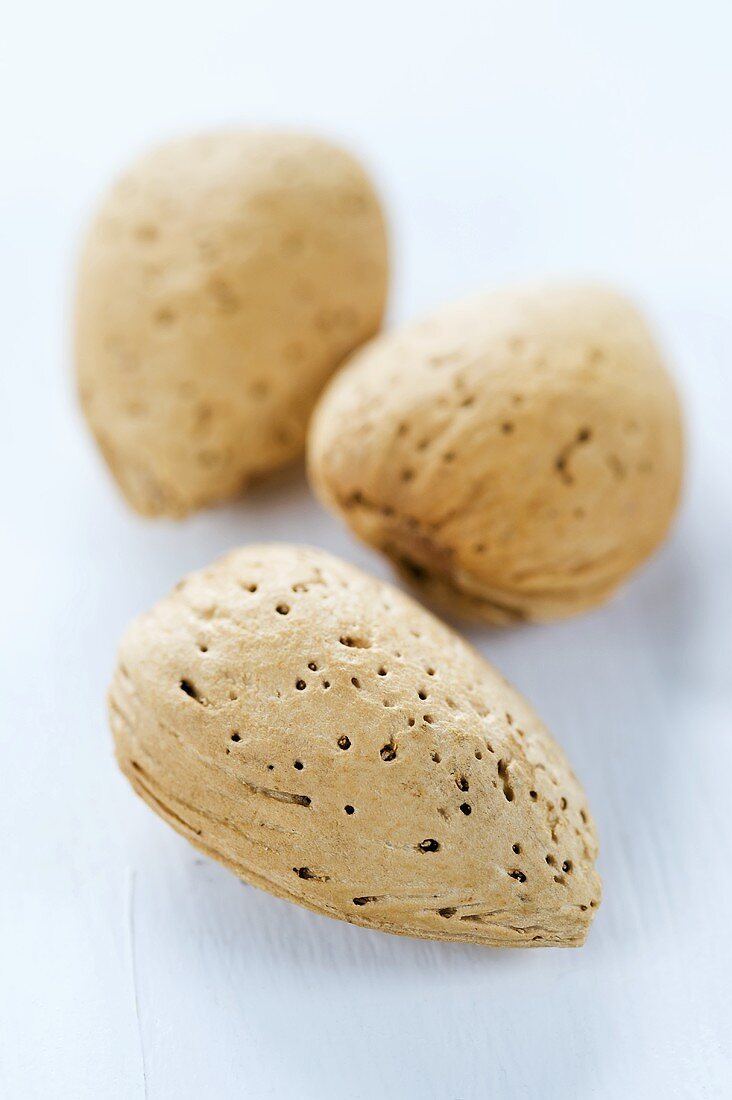 Three unpeeled almonds (close-up)