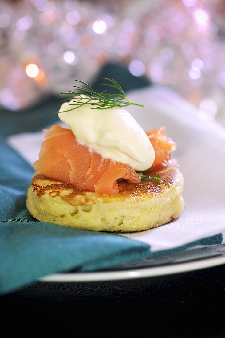 A blini with smoked salmon and sour cream