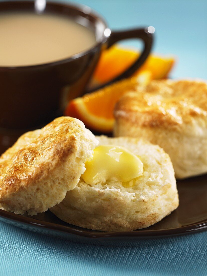 Buttermilk biscuits with butter and a cup of tea