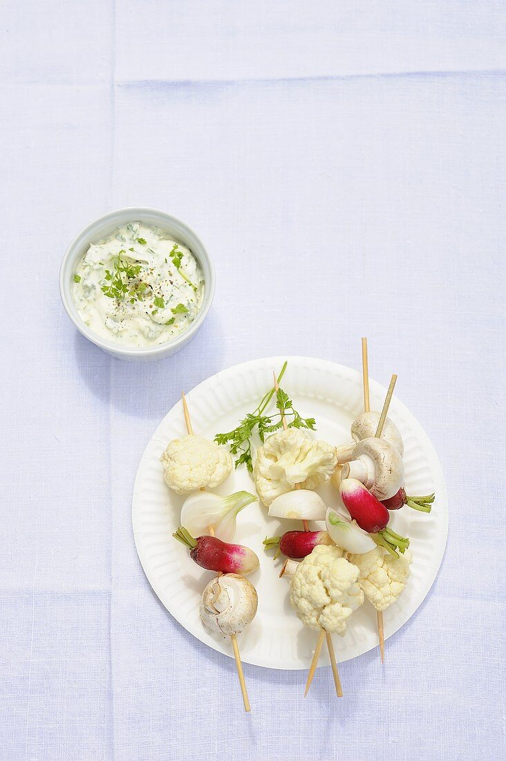 Raw vegetable kebabs with a dip