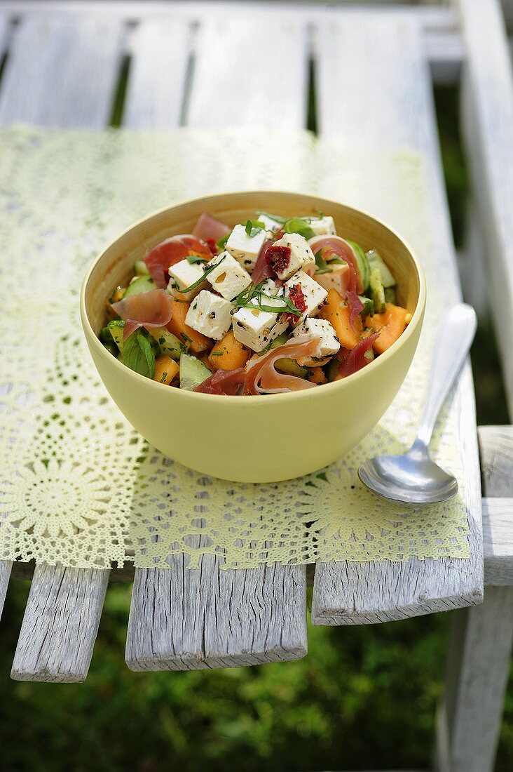 Melon salad with feta cheese and ham