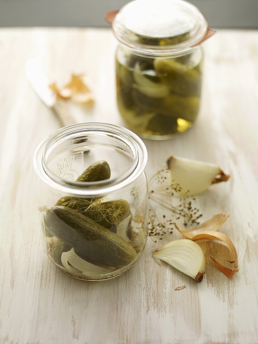 Gherkins in a jar with dill and onions