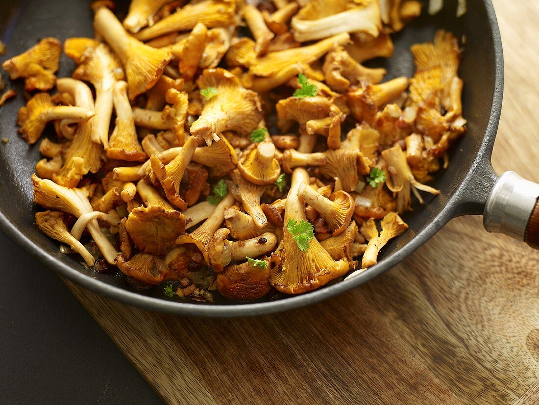 Chanterelle mushrooms with parsley in a pan
