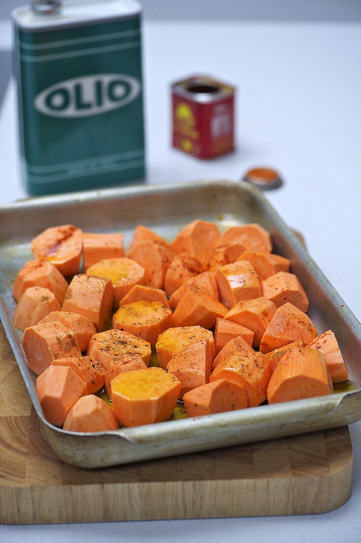 Sweet potatoes with coriander on a baking tray