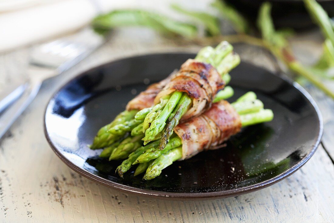 Green asparagus wrapped in Parma ham