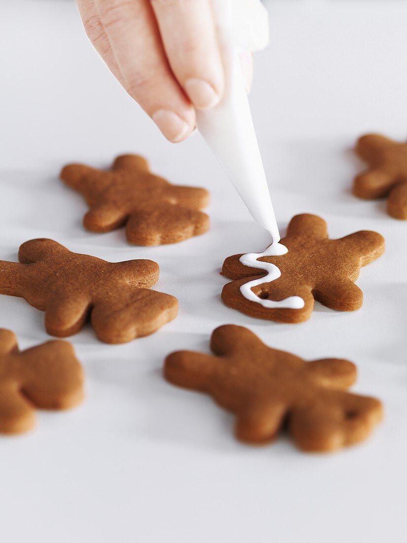 Gingerbread men being decorated
