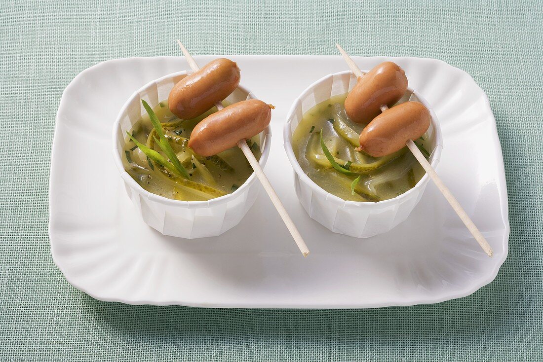 Gherkin and onion sauce with tarragon and sausage kebabs