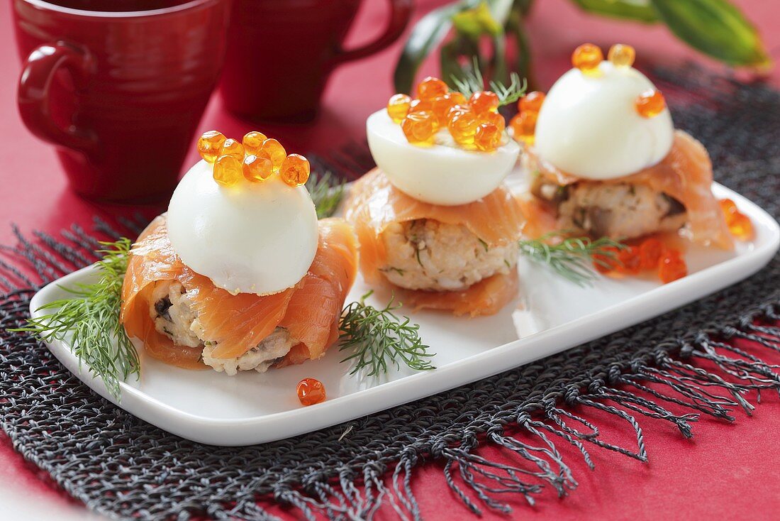 Rice canapes with smoked salmon, egg and caviar