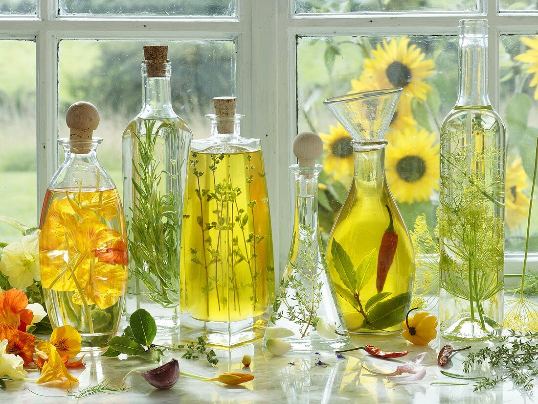 Various herbal oils in bottles on a window sill