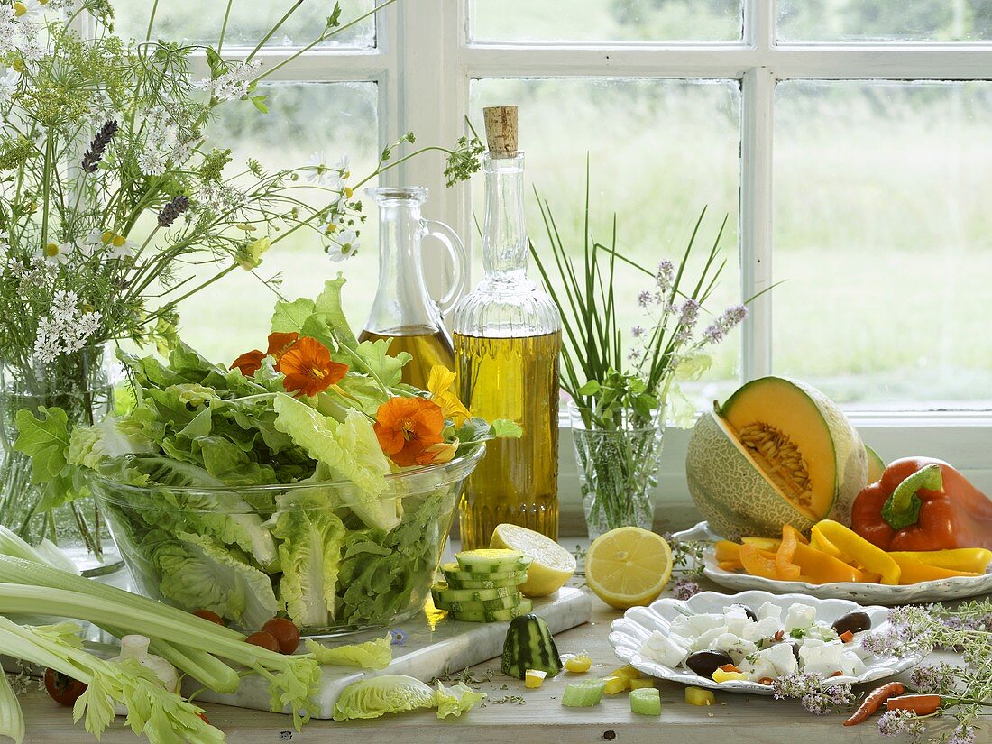 Summer salad and ingredients on a window sill
