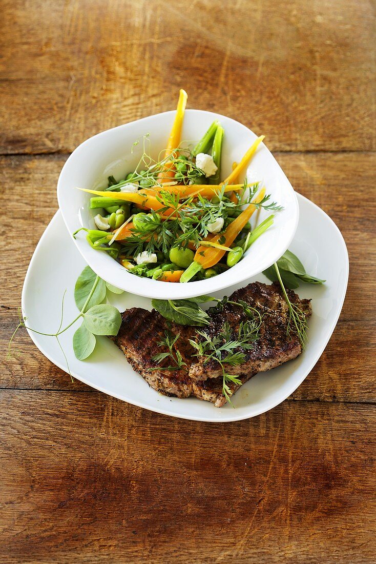 Carrots with broad beans and grilled chops