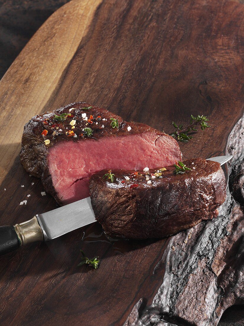 Roast fillet of beef on a wooden board