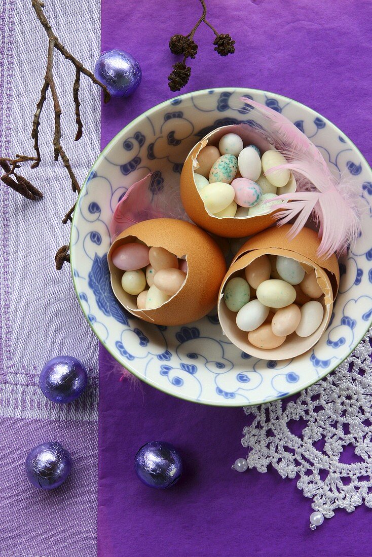 Three egg shells filled with sugar eggs