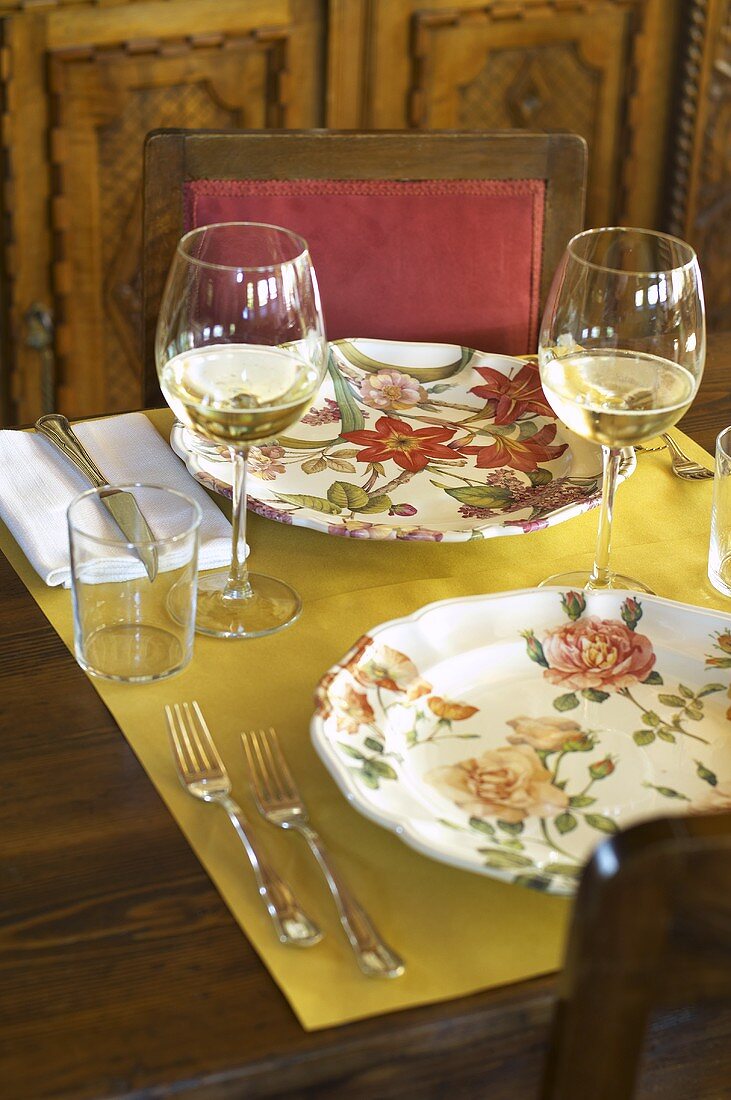 A table laid for two people with white wine