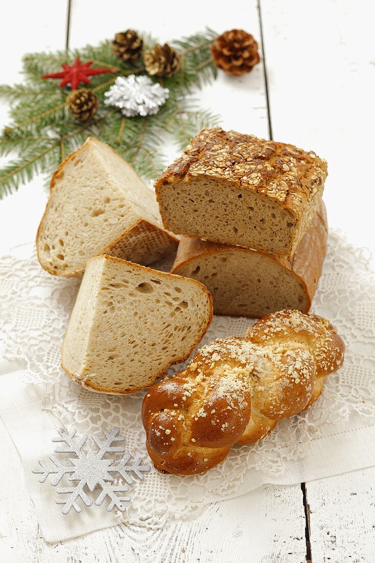 Various types of bread, a plaited loaf and Christmas decorations