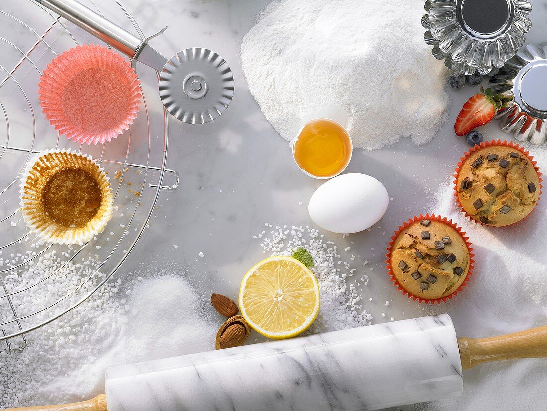 Baking ingredients, baking utensils and muffins