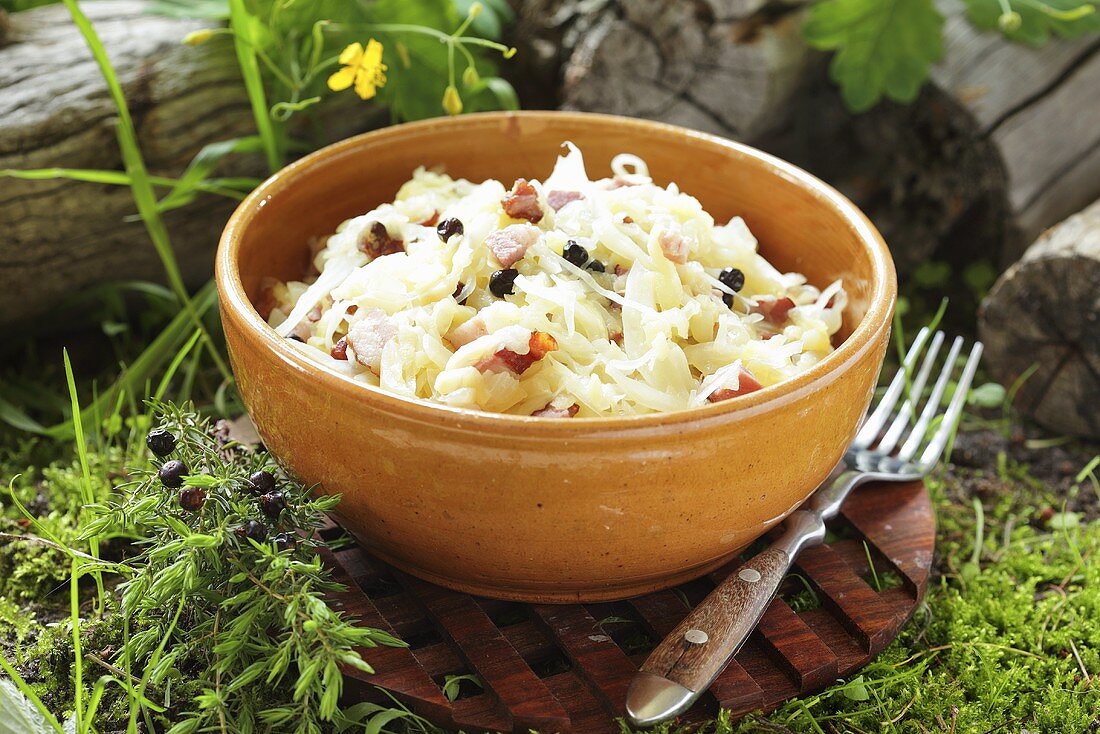 Steamed white cabbage with bacon and juniper berries and fresh herbs