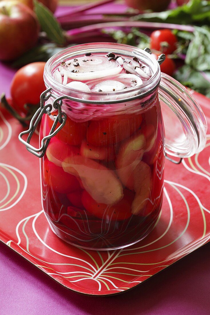 Pickled tomatoes and onions in a preserving jar