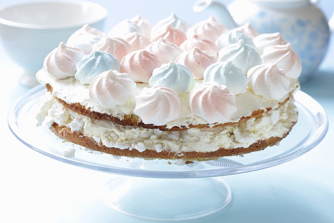 Layered tart with pastel-coloured meringue