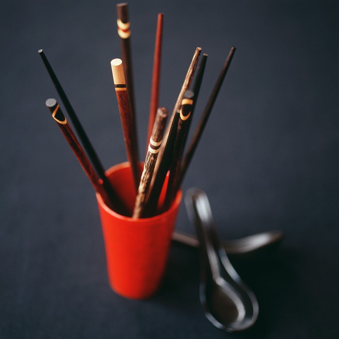 Various chopsticks in a wooden cup