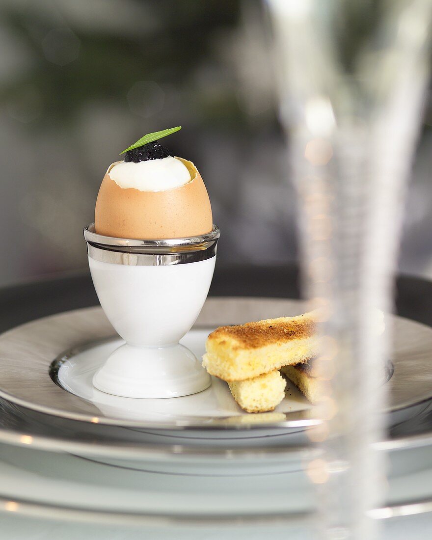 Boiled egg with sour cream and caviar