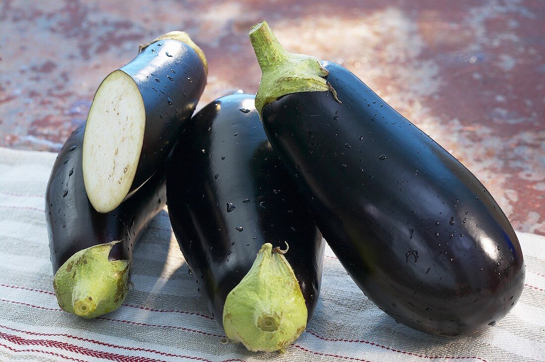 Aubergines, whole and halved