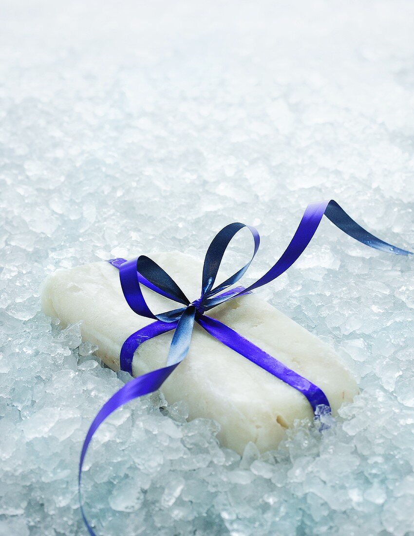 Frozen fish with bow on crushed ice