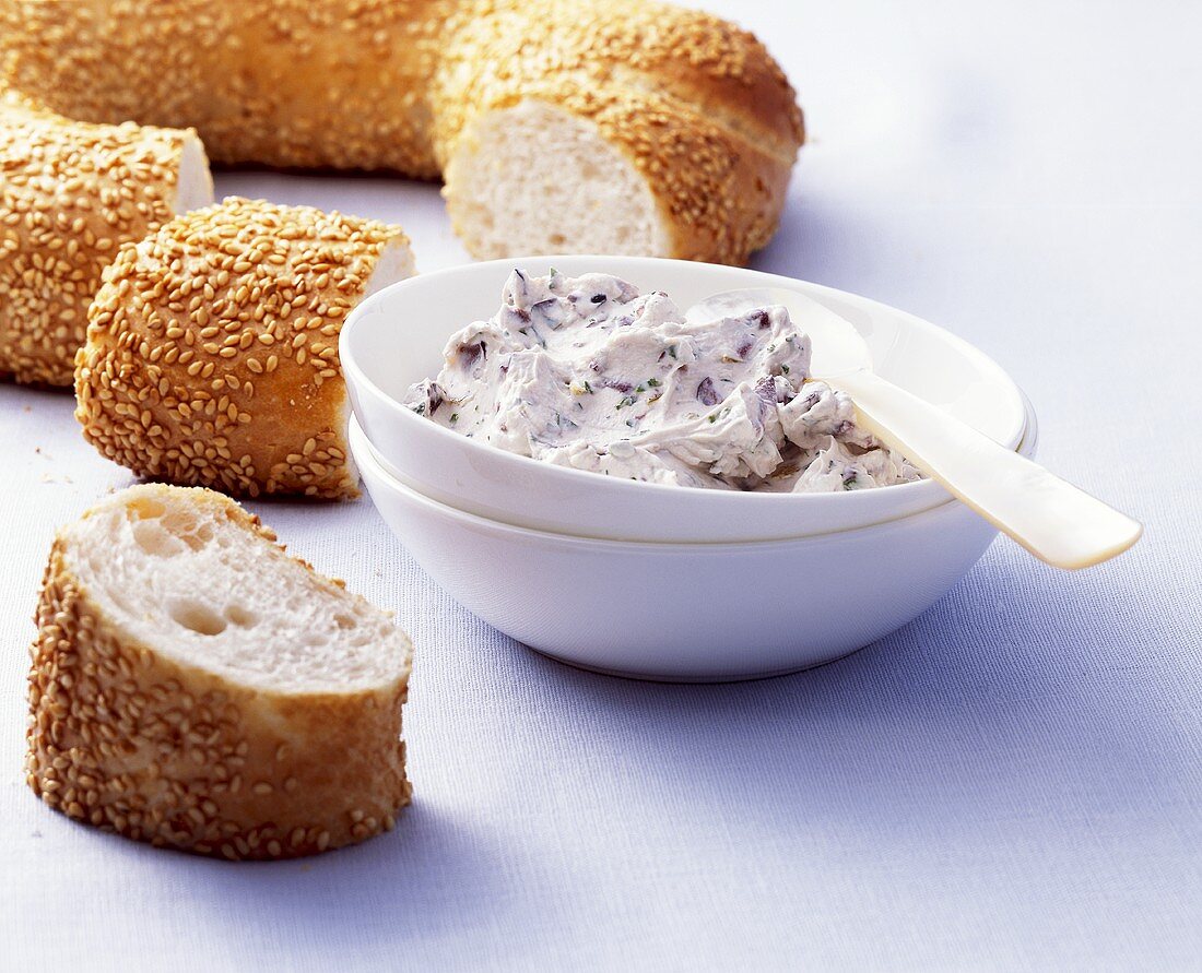 Soft cheese dip with olives to serve with sesame bread