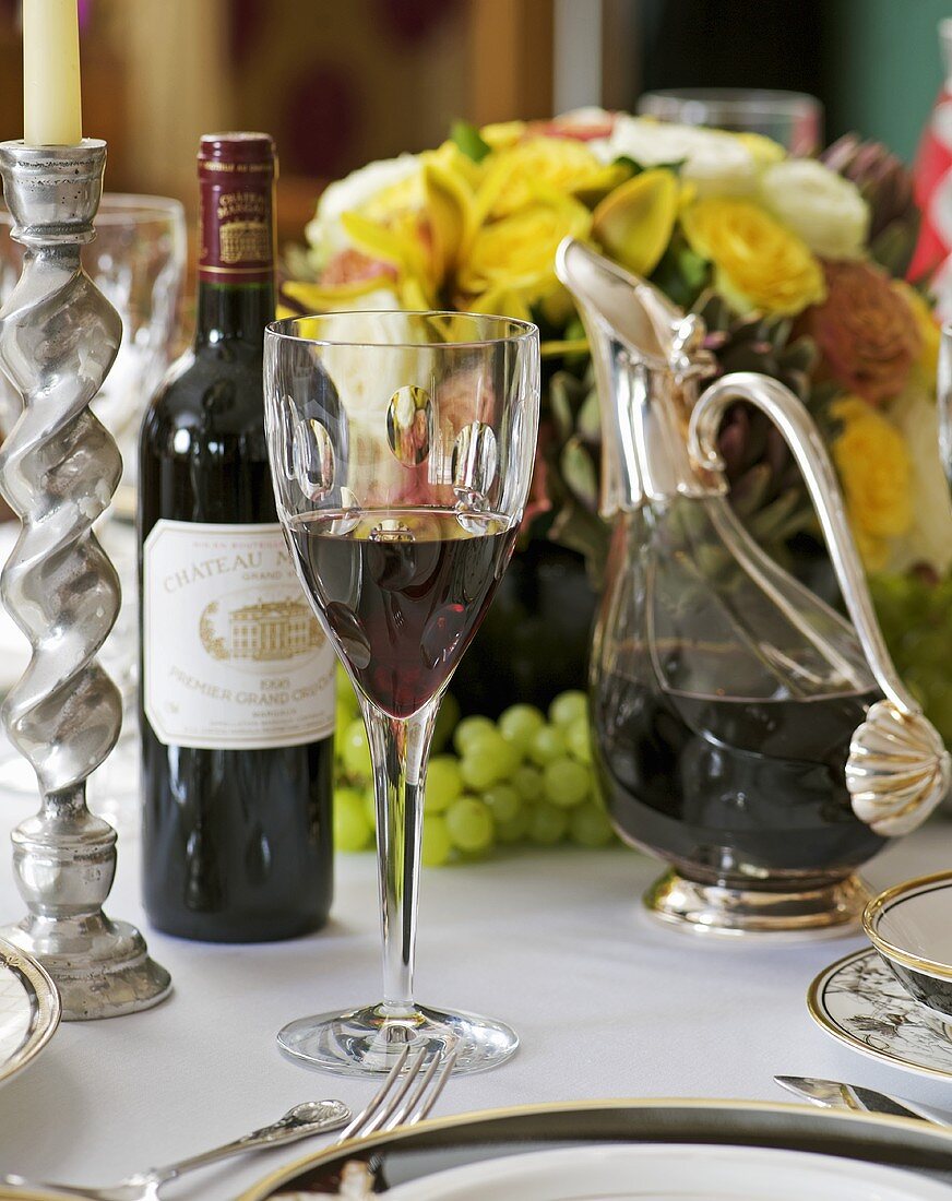 Red wine on table laid for special occasion
