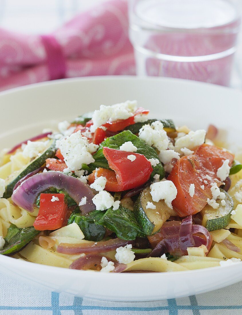 Tagliatelle with courgettes, tomatoes, peppers, onions & feta