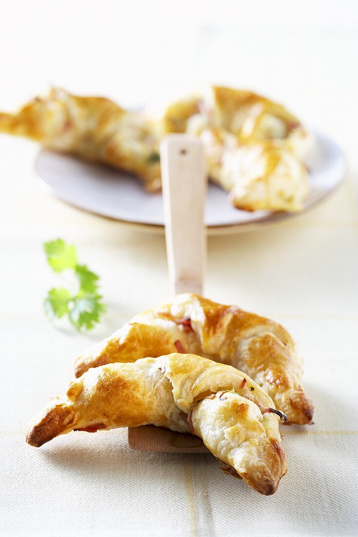 Puff pastry croissants filled with bacon and herbs