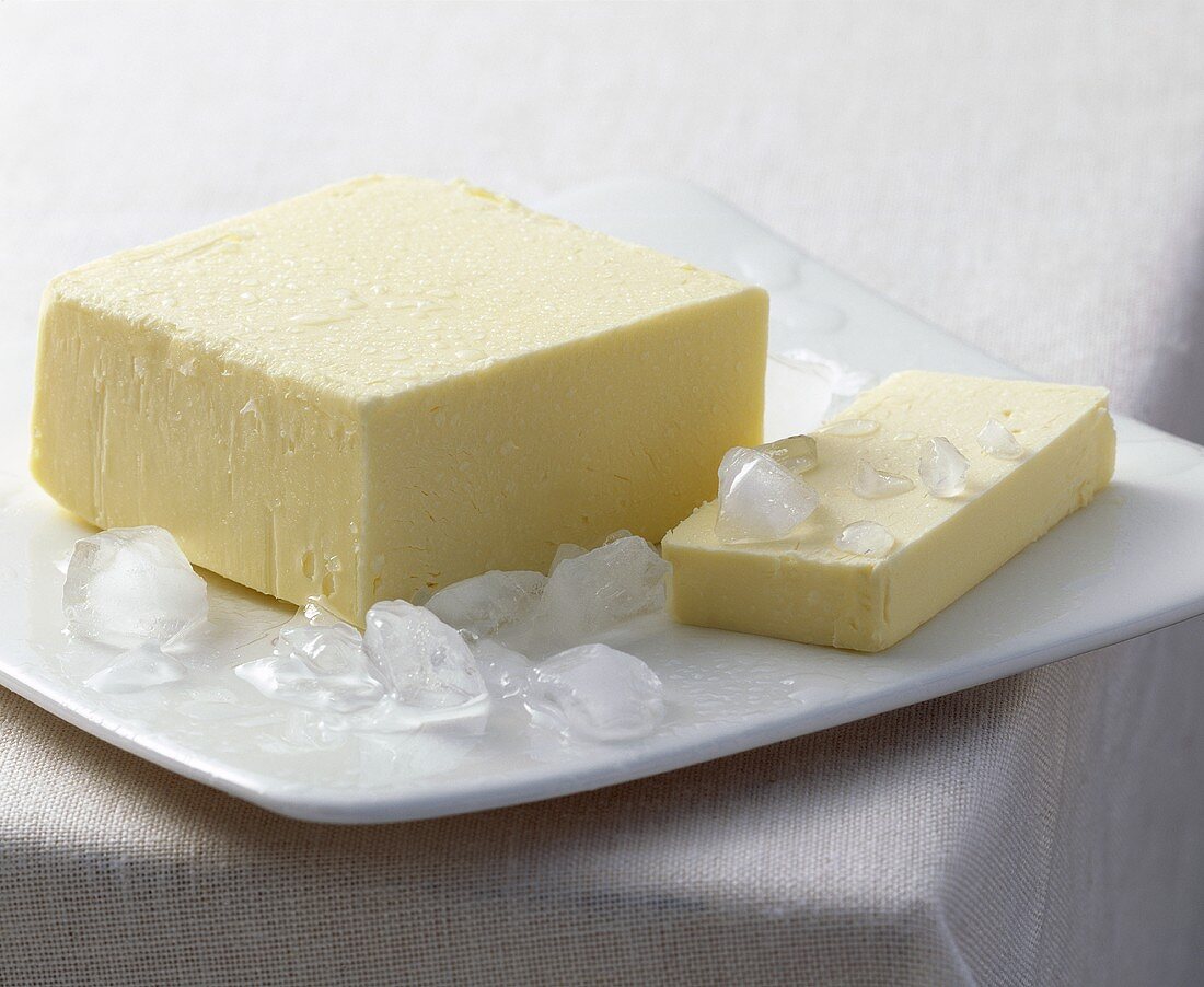Butter with ice cubes on a plate