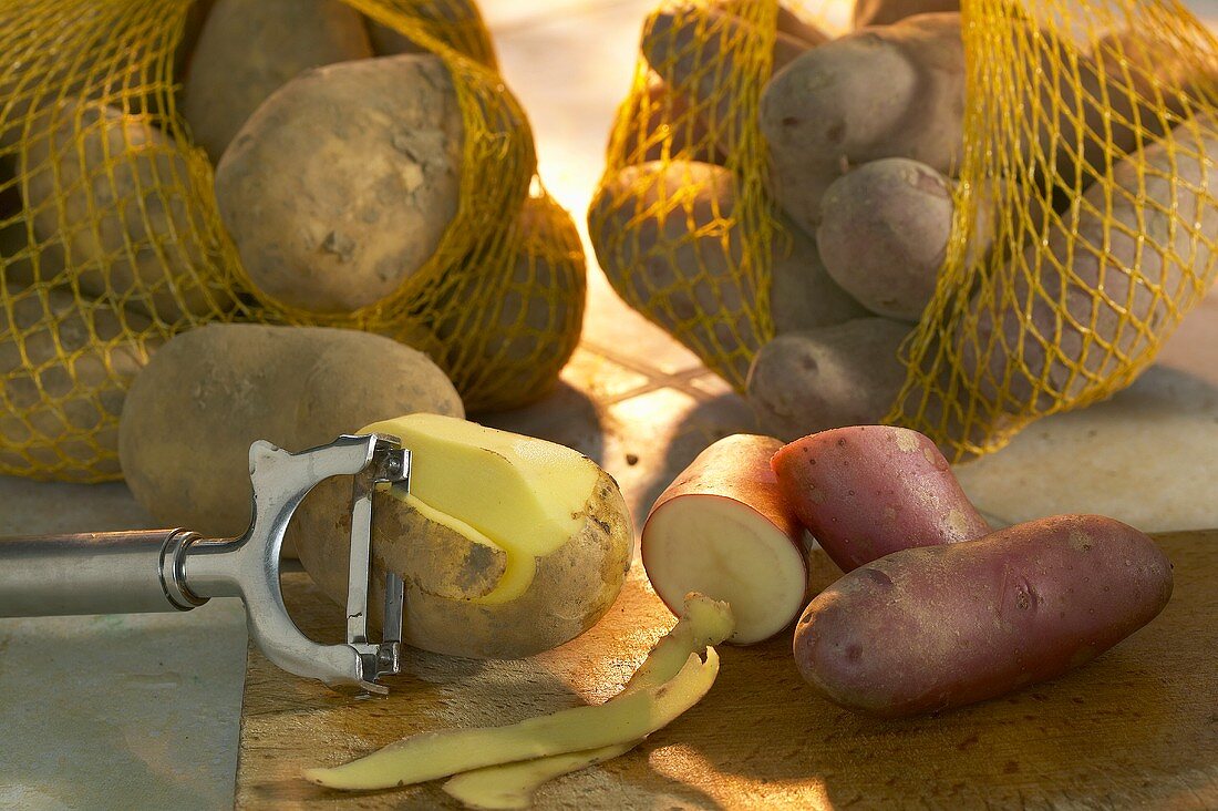 Potatoes in nets and with potato peeler