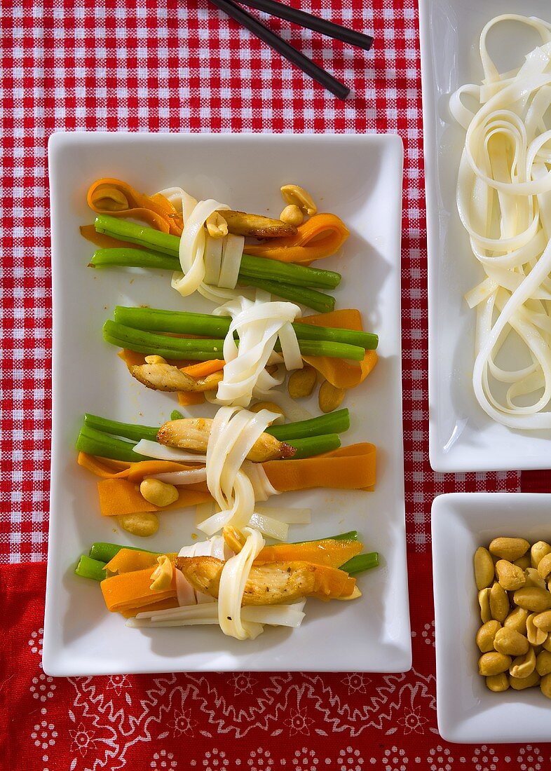 Carrots, beans and chicken fillet tied with noodles
