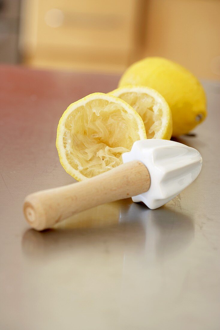 Squeezed lemon halves with lemon reamer