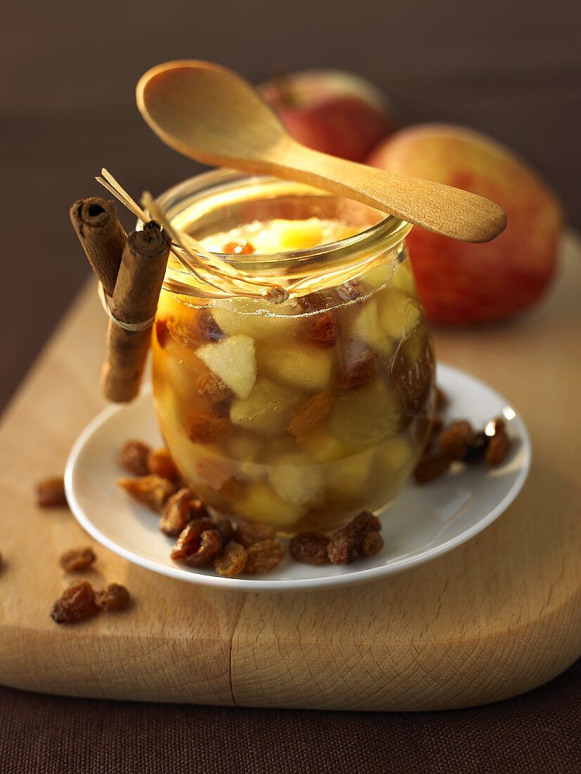 Winter jam made with apples and raisins in preserving jar